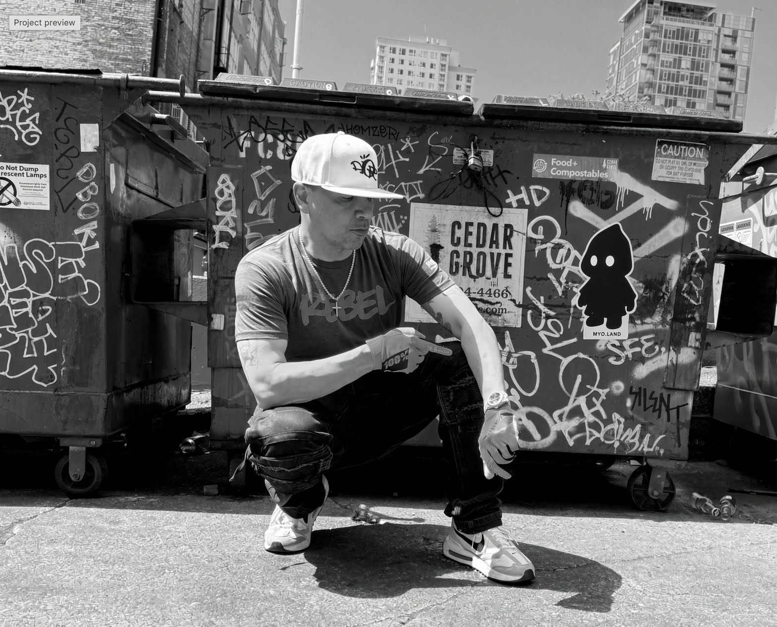 Mix Master Mike in an alley in front of graffiti